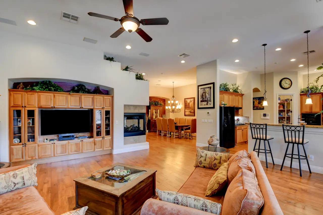 Family room with a built-in entertainment center and a multi-sided fireplace