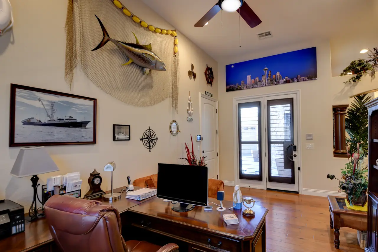 Flex room set up as an office, with French doors to its own entrance